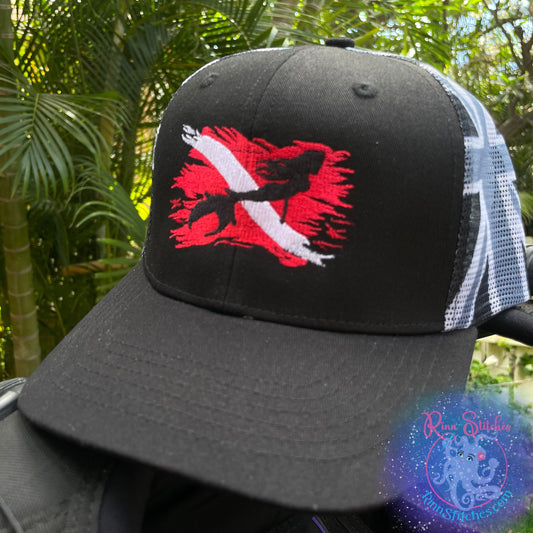 Black Cap with embroidered design of a red and white tattered dive flag with a mermaid silhouette in the center. Made by Rinn Stitches in Maui, Hawaii