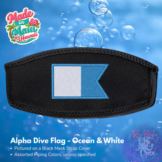 An Alpha Dive Flag strap cover featuring a black neoprene strap with a stitched border and a central flag patch in white and light blue. The background is a blue water-themed graphic with bubbles, made by Rinn Stitches in Maui, Hawaii