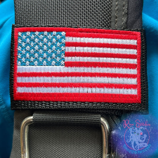 Embroidered BCD Tag Featuring a bold American flag design, in traditional red, white, and blue on Black Webbing. Made for scuba divers by Rinn Stitches in Maui, Hawaii
