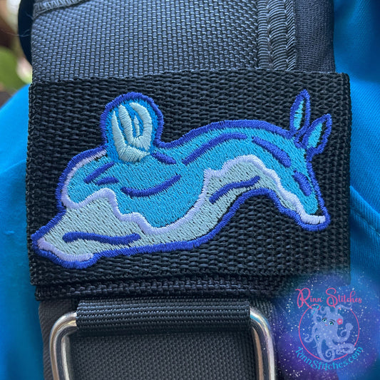 Embroidered BCD Tag with a Blue Nudibranch Babosa de mar Design on Black Webbing. Made for scuba divers by Rinn Stitches in Maui, Hawaii