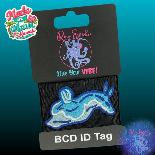 Embroidered BCD Tag with a Blue Nudibranch Babosa de mar Design on Black Webbing. Made for scuba divers by Rinn Stitches in Maui, Hawaii