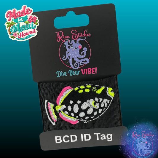 Clown Triggerfish embroidered design on a black BCD tag featuring bright neon yellow and neon pink accents on it's black and white spotted body. Made by Rinn Stitches in Maui, Hawaii