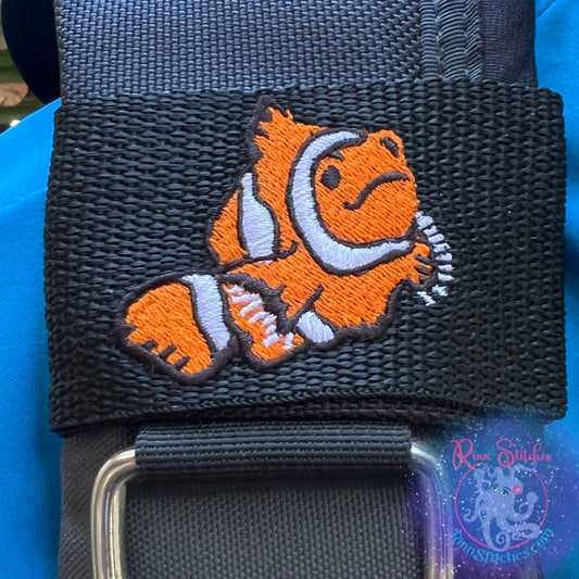 Embroidered BCD Tag Featuring a playful clownfish design that pops with a subtle 3D effect, like it’s swimming right toward you on Black Webbing. Made for scuba divers by Rinn Stitches in Maui, Hawaii