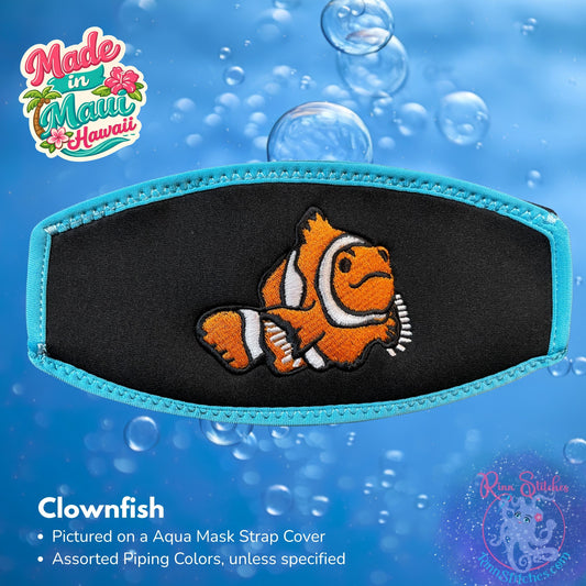 Embroidered neoprene mask strap cover featuring a bright orange clownfish design. Made in Maui, Hawaii by Rinn Stitches