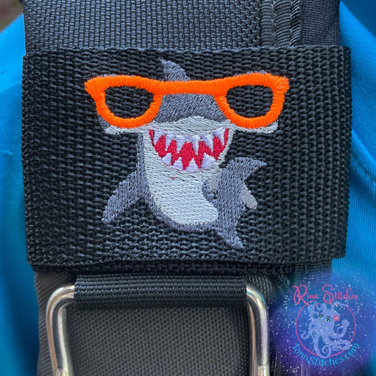 Embroidered BCD Tag with a fun cartoon style Hammerhead shark wearing neon orange sunglasses on Black Webbing. Made for scuba divers by Rinn Stitches in Maui, Hawaii