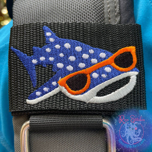 Embroidered BCD Tag featuring a cool whale shark rocking sunglasses, available in assorted color variations on Black Webbing. Made for scuba divers by Rinn Stitches in Maui, Hawaii