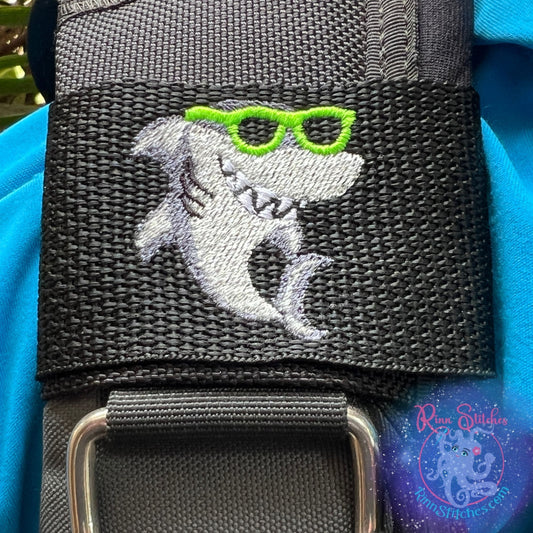 Embroidered BCD Tag with a cute cartoon style shark wearing neon green sunglasses on Black Webbing. Made for scuba divers by Rinn Stitches in Maui, Hawaii