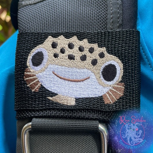 Embroidered BCD Tag Featuring a smiling pufferfish design that’s equal parts cute and eye-catching on Black Webbing. Made for scuba divers by Rinn Stitches in Maui, Hawaii