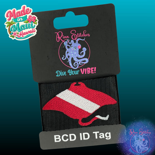 Embroidered BCD Tag with a Red & White Dive Flag in the shape of a manta ray silhouette on Black Webbing. Made for scuba divers by Rinn Stitches in Maui, Hawaii