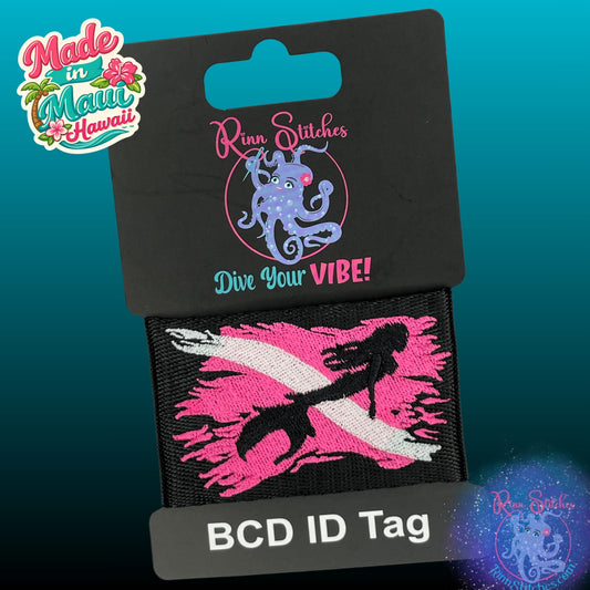Embroidered BCD Tag with a neon pink & white Tattered Dive Flag with a majestic mermaid silhouette on Black Webbing. Made for scuba divers by Rinn Stitches in Maui, Hawaii