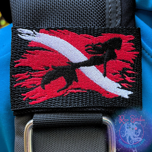 Embroidered BCD Tag with a Red & White Tattered Dive Flag with a majestic mermaid silhouette on Black Webbing. Made for scuba divers by Rinn Stitches in Maui, Hawaii