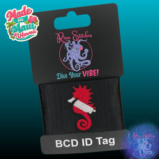 Embroidered BCD tag on black webbing featuring a red and white dive flag in the shape of a seahorse. Made by Rinn Stitches in Maui, Hawaii