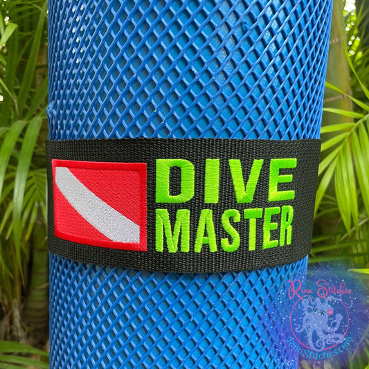 Embroidered scuba tank band featuring a bright red and white dive flag and the text Dive Master in neon Green for excellent visibility above and below the water. Made by Rinn Stitches in Maui, Hawaii