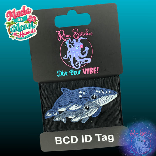 BCD Tag on black webbing featuring an embroidered humpback mama and calf design. Sure to steal heart of any diver or ocean lover. Made by Rinn Stitches on Maui, Hawaii