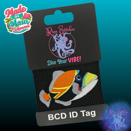 Embroidered BCD Tag Featuring the Humuhumunukunukuapua'a Reef Triggerfish, Hawaii’s state fish, brought to life in a bold, colorful design on Black Webbing. Made for scuba divers by Rinn Stitches in Maui, Hawaii