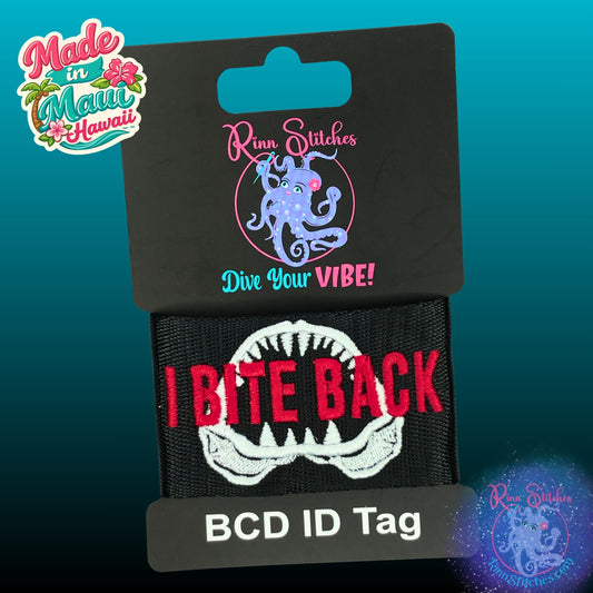 Embroidered BCD Tag with a Shark Jaw Design and humorous phrase "I Bite Back"  on Black Webbing. Made for scuba divers by Rinn Stitches in Maui, Hawaii