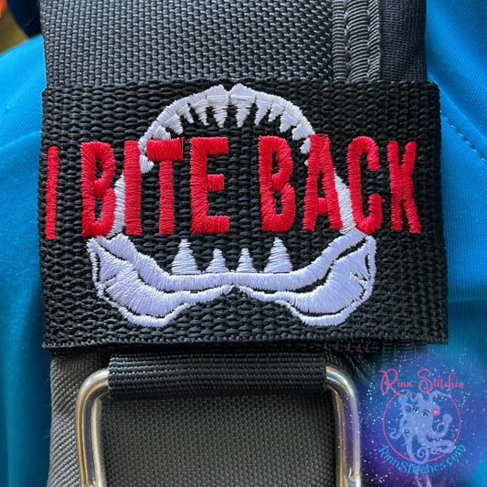 Embroidered BCD Tag with a Shark Jaw Design and humorous phrase "I Bite Back"  on Black Webbing. Made for scuba divers by Rinn Stitches in Maui, Hawaii