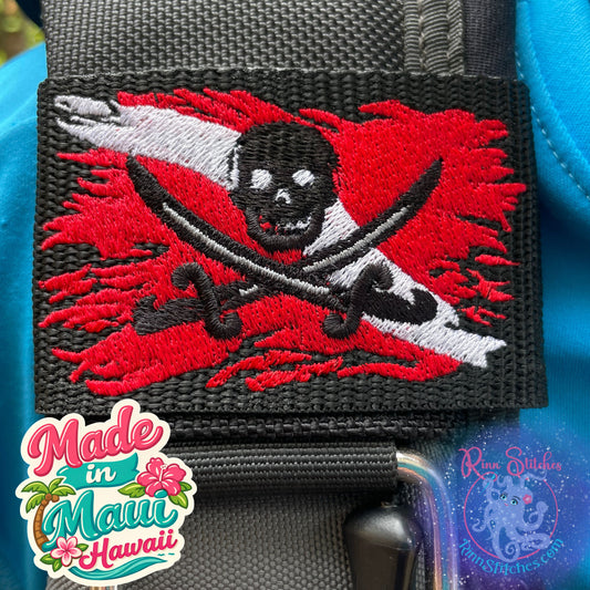 Embroidered BCD Tag with the iconic Jolly Roger Design centered on a red and white dive flag on Black Webbing. Made for scuba divers by Rinn Stitches in Maui, Hawaii