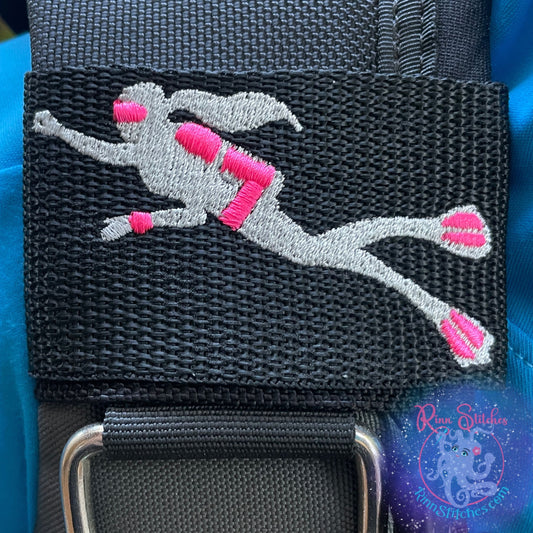 Embroidered BCD Tag with a lady scuba diver in silver and neon pink gear accents on Black Webbing. Made for scuba divers by Rinn Stitches in Maui, Hawaii