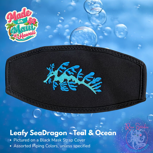 Black mask strap cover featuring a teal and blue leafy sea dragon graphic, shown against an underwater bubble background with 'Made in Maui Hawaii' by Rinn Stitches