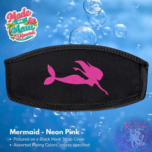 A black neoprene mask strap cover featuring a neon pink mermaid silhouette design, shown against a blue bubbly underwater-themed background Made by Rinn Stitches in Maui, Hawaii