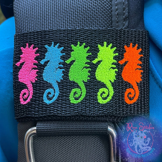 Embroidered BCD Tag Featuring a vibrant lineup of five neon-colored seahorses that pop on your gear on Black Webbing. Made for scuba divers by Rinn Stitches in Maui, Hawaii
