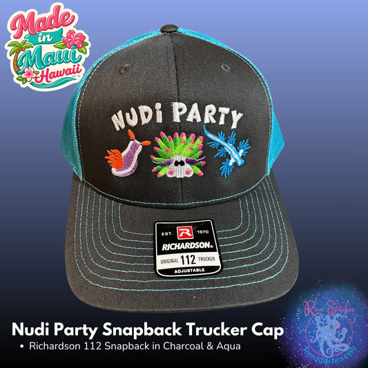 A charcoal gray and aqua mesh trucker cap with embroidered 'NUDI PARTY' text and colorful nudibranch motifs on the front. The cap features a Richardson 112 snapback sticker on the brim and is shown against a blue gradient background with promotional text and logos. Made by Rinn Stitches in Maui, Hawaii