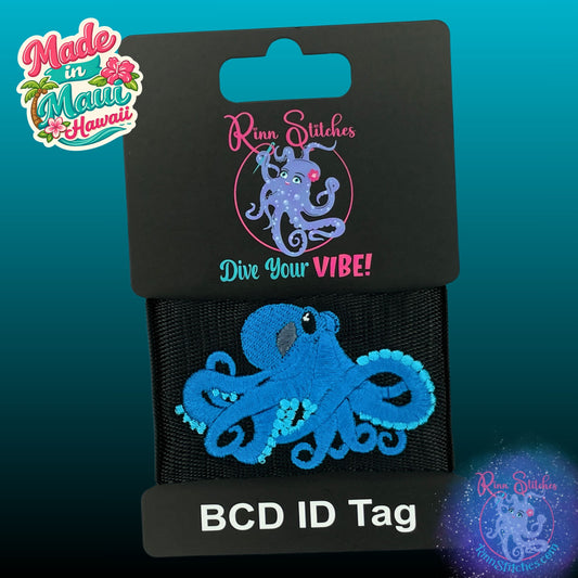 Embroidered BCD Tag Featuring an octopus design with a 3D effect that enhances depth, produced in ocean and blue skies on Black Webbing. Made for scuba divers by Rinn Stitches in Maui, Hawaii
