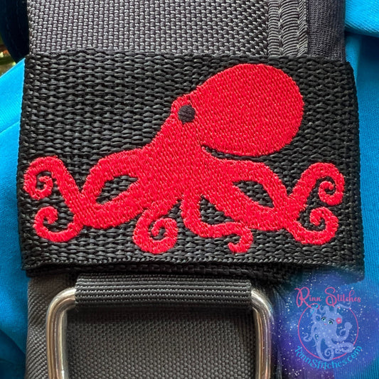 Embroidered BCD Tag featuring an octopus silhouette design in red thread on Black Webbing. Made for scuba divers by Rinn Stitches in Maui, Hawaii