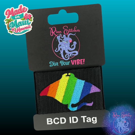 Embroidered BCD Tag Featuring a bold rainbow manta ray design that celebrates Pride and self-expression on Black Webbing. Made for scuba divers by Rinn Stitches in Maui, Hawaii