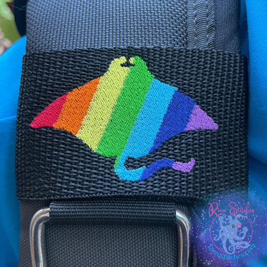 Embroidered BCD Tag Featuring a bold rainbow manta ray design that celebrates Pride and self-expression on Black Webbing. Made for scuba divers by Rinn Stitches in Maui, Hawaii