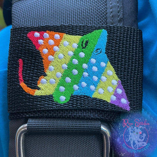 Embroidered BCD Tag with a Rainbow Spotted Eagle Ray Design on Black Webbing. Made for scuba divers by Rinn Stitches in Maui, Hawaii