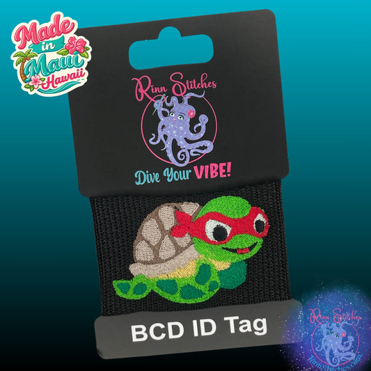 Embroidered BCD Tag Featuring a sea turtle ninja design with red color mask on Black Webbing. Made for scuba divers by Rinn Stitches in Maui, Hawaii