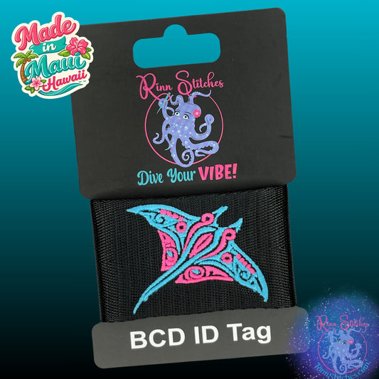 Embroidered BCD Tag Featuring a two-tone tribal manta ray design, shown in Neon Pink & Blue Skies on Black Webbing. Made for scuba divers by Rinn Stitches in Maui, Hawaii